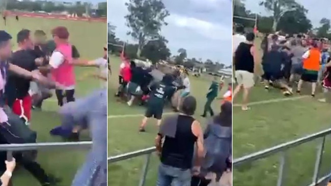 Rival spectators fight on the field during an Under-13s rugby league game in Brisbane.