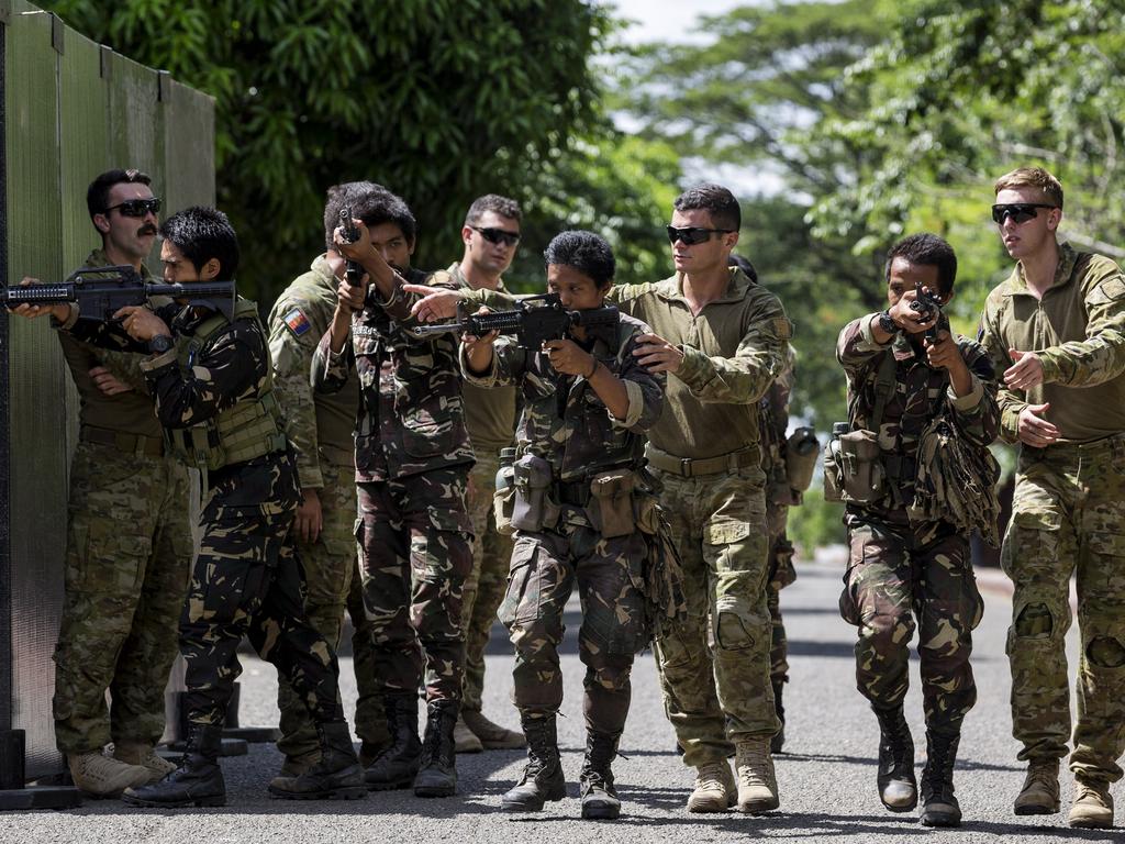 Australian Army soldiers assist Army Scout Ranger trainees during an obstacle crossing exercise in the Philippines. Picture: Australian Defence Force