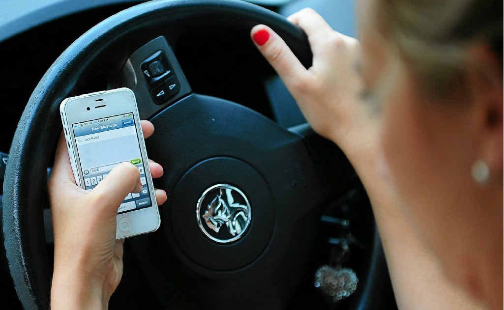 Having a mobile phone in hand while driving could cost you $330 and 3 demerit points. Picture: Tom Huntley