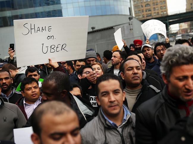 NEW YORK, NY - FEBRUARY 01: Uber drivers protest the company's recent fare cuts and go on strike in front of the car service's New York offices on February 1, 2016 in New York City. The drivers say Uber continues to cut into their earnings without cutting into its own take from each ride. In claiming fare reduction would mean more work for drivers, the San Francisco based company cut its prices by 15 percent last week. Spencer Platt/Getty Images/AFP == FOR NEWSPAPERS, INTERNET, TELCOS & TELEVISION USE ONLY ==