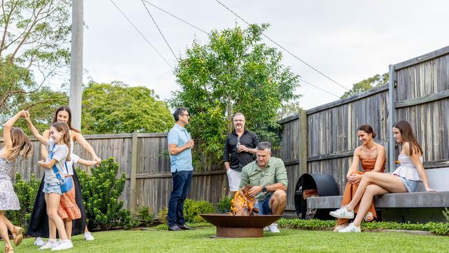 Dennis Scott entertains family and friends around his freshly mowed lawn. Picture by Luke Marsden.