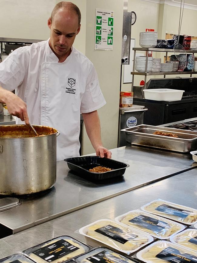 HEARTY: Chef Chris Eyles preparing lasagne meals in the Southern Cross University catering kitchen.