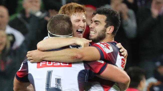 The Melbourne Rebels celebrate their win on full time to beat the Brumbies.