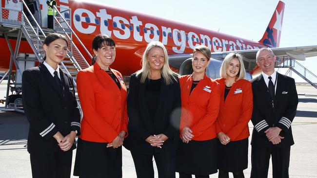 Jetstar Group CEO Stephanie Tully, centre, poses with airline staff during an announcement at Brisbane Airport. Picture: NCA NewsWire/Tertius Pickard