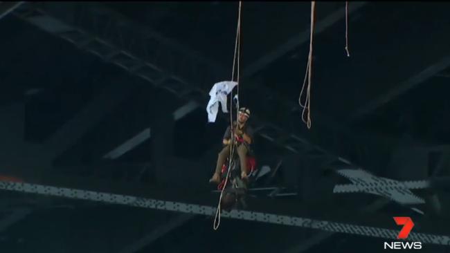 A Greenpeace protester hangs from the bridge. Picture: 7NEWS Sydney