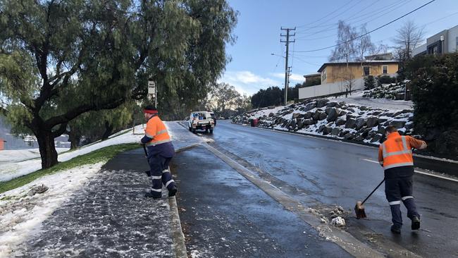 Metro workers Scott Shepard and Shane Davis were called to assist a bus that was stuck on ice at a bus stop in Trevallyn just before 9am. Picture: PATRICK GEE