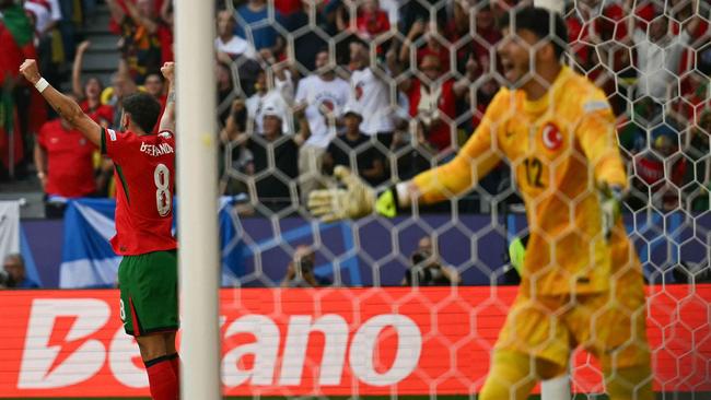 Portugal celebrate the own goal. Photo by OZAN KOSE / AFP