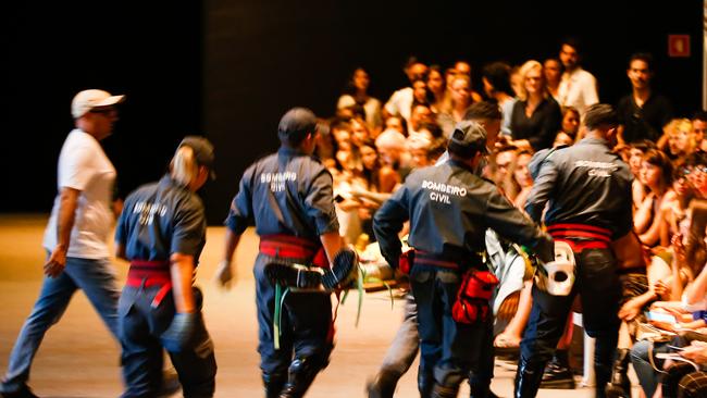 Medics rush to help during the Ocksa fashion show. Picture: Getty