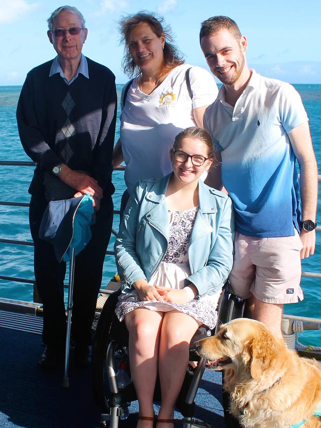 Erin Condrin (bottom) with her assistance dog Lacey on Sunlover Reef Cruises' pontoon at Moore Reef.