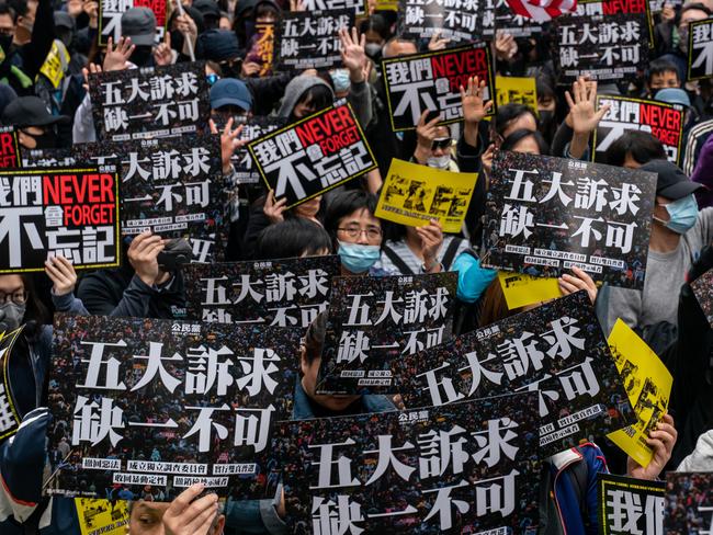 HONG KONG, CHINA - JANUARY 1: Pro-democracy supporters hold placards and shout slogan as they take part in a march during a rally on New Years Day on January 1, 2020 in Hong Kong, China. Anti-government protesters in Hong Kong continue their demands for an independent inquiry into police brutality, the retraction of the word "riot" to describe the rallies, and genuine universal suffrage. (Photo by Anthony Kwan/Getty Images)