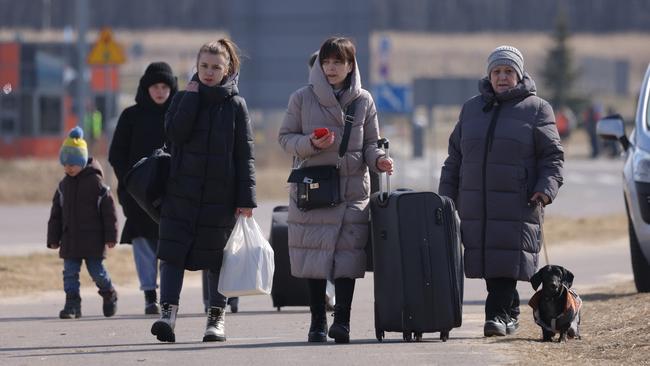 Women and children who said they fleeing from nearby Yavoriv in Ukraine arrive in Poland at the Budomierz border crossing. Picture: Getty