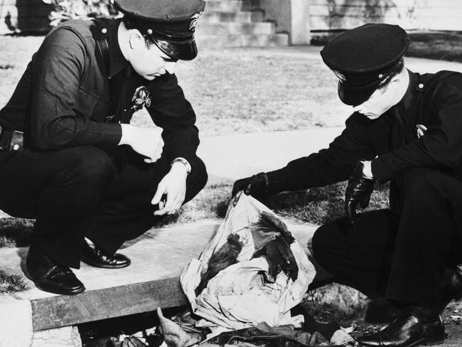 LA police examine bloodstained clothing found in a drain. Picture: Getty