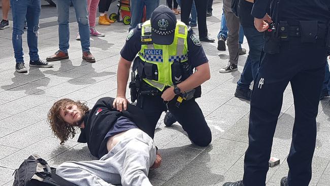 Barry Siecker is arrested in Rundle Mall after bashing a Fringe performer with his own ukulele. Picture: Shaun Hollis