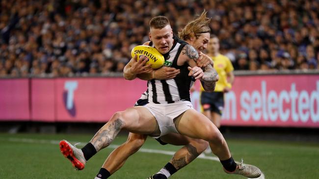 Tom Stewart wraps up Jordan De Goey in the opening minutes of Friday’s qualifying final. Picture: Michael Willson/AFL Photos via Getty Images.