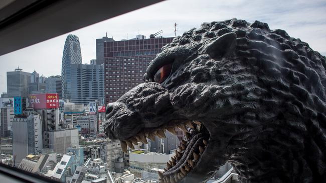 12m Godzilla replica head is seen through the ninth floor of hotel room window. Photo: Getty Images