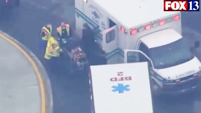 An injured person is taken away by paramedics.