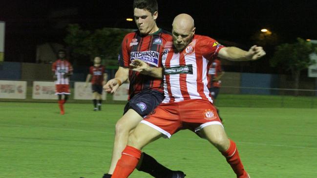 Darwin Olympic's skipper Mitch Amidy holds off Palmerston opponent Aiden Elton in their FFA Cup qualifier at Larrakia Park. Picture: Lou Reeve