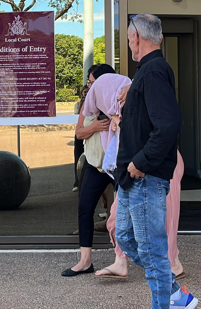 A Top End childcare centre manager Tara Eva Harding is escorted from Darwin Local Court bundled in a pink sweater by her family after facing commercial quantity drug charges.