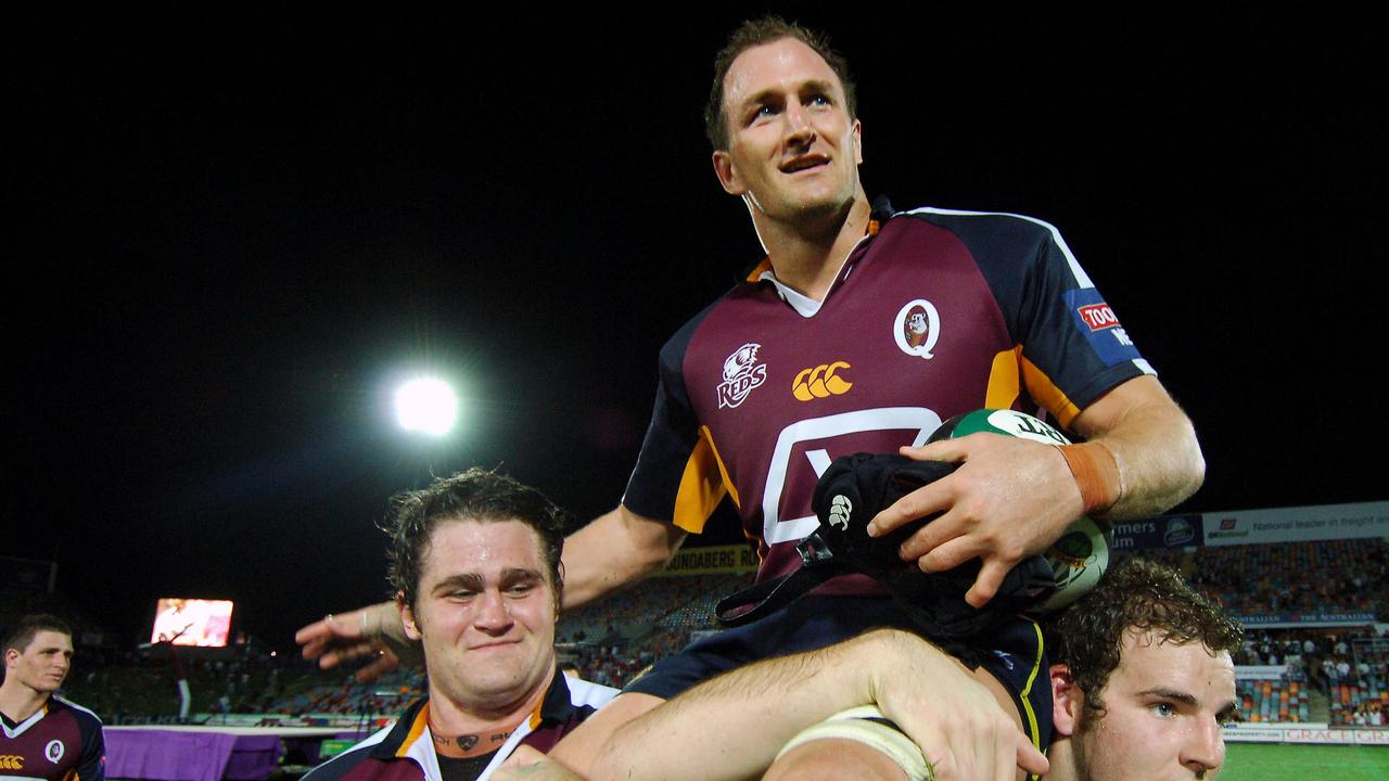 After playing a record 134 games for the Reds Mark Connors celebrates on the shoulders of James Horwill (left) and Stepher Moore (right) in Townsville, Friday, May 12, 2006.