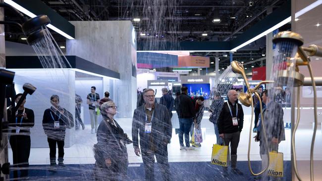 People look at shower heads at the Kohler Company exhibit. Picture: AFP