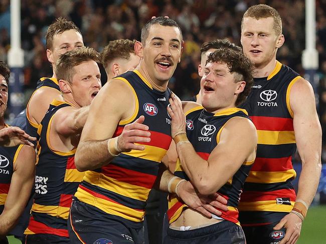 ADELAIDE, AUSTRALIA - JULY 29: Taylor Walker of the Crows winner of the Showdown Medal with team mates during the 2023 AFL Round 20 match between the Adelaide Crows and the Port Adelaide Power at Adelaide Oval on July 29, 2023 in Adelaide, Australia. (Photo by Sarah Reed/AFL Photos via Getty Images)