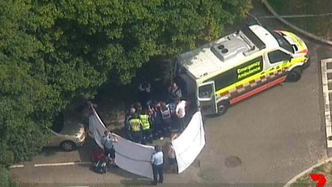 Ambulance crews treat the boy at the Spit Reserve carpark. Pic: Seven News