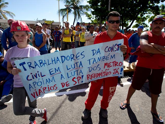 Construction workers hold a poster that reads in Portuguese "Construction workers fight too, we support the fight of Sao Paulo's Metro workers". Demonstrators shouted slogans against Brazil's president Dilma Rousseff and the World Cup.