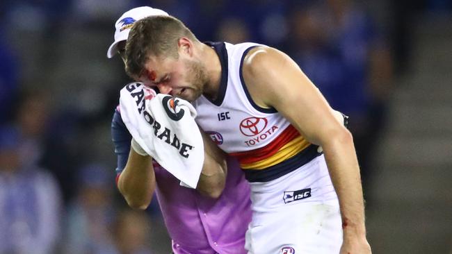 Brad Crouch of the Crows leaves the field injured during the round four AFL match between the North Melbourne Kangaroos and the Adelaide Crows at Marvel Stadium on April 13, 2019 in Melbourne, Australia. Picture: Scott Barbour/Getty Images