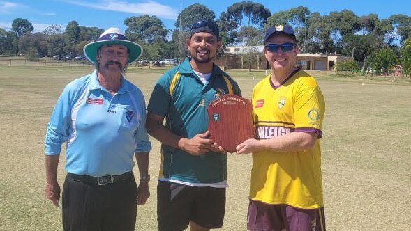 Bihan Weerakoon and Ryan Chapple show off the shield with umpire Ray Noon.