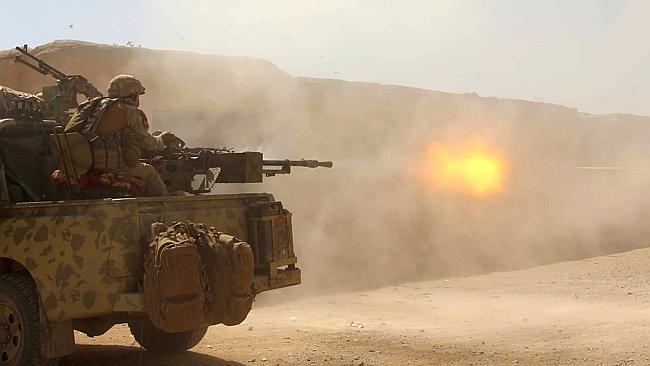 Afghan National Army commandos open fire on a Taliban position in Helmand province.