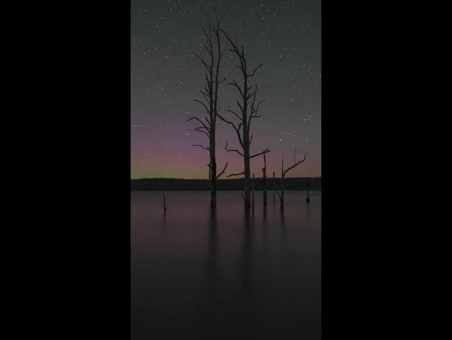 Comet streaks across the sky during colourful Aurora Australis