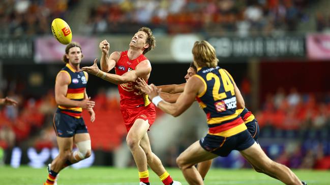 GOLD COAST, AUSTRALIA - MARCH 16: Noah Anderson of the Suns handballs during the round one AFL match between Gold Coast Suns and Adelaide Crows at People First Stadium, on March 16, 2024, in Gold Coast, Australia. (Photo by Chris Hyde/Getty Images)