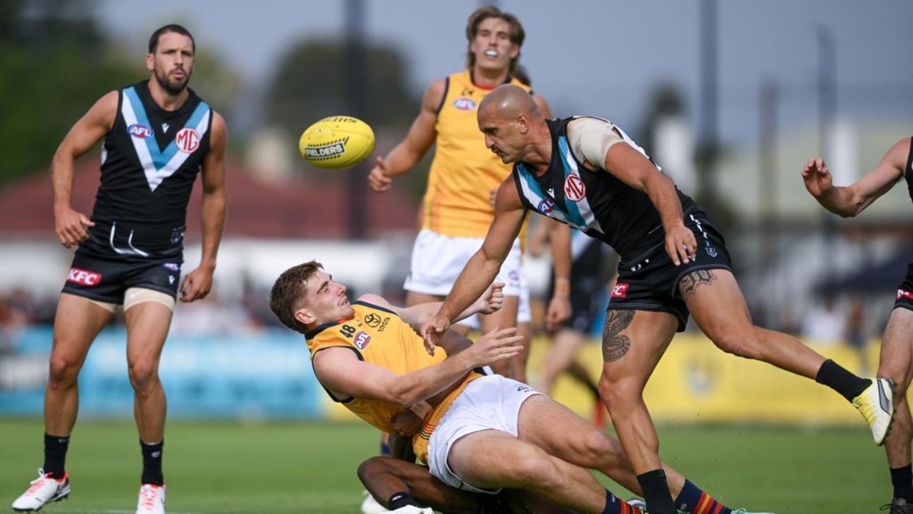 Mark Keane of the Crows tackled by Willie Rioli of the Power as Sam Powell-Pepper cannons into him. Picture: Mark Brake/Getty Images.