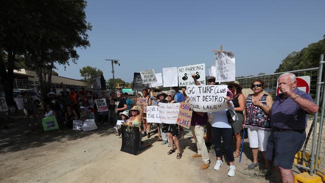 Black Swan Lake protest at Bundall goes to another level, with protesters chaining themselves to the fence and then getting themselves arrested after running onto the worksite and stopping the trucks … Picture Glenn Hampson