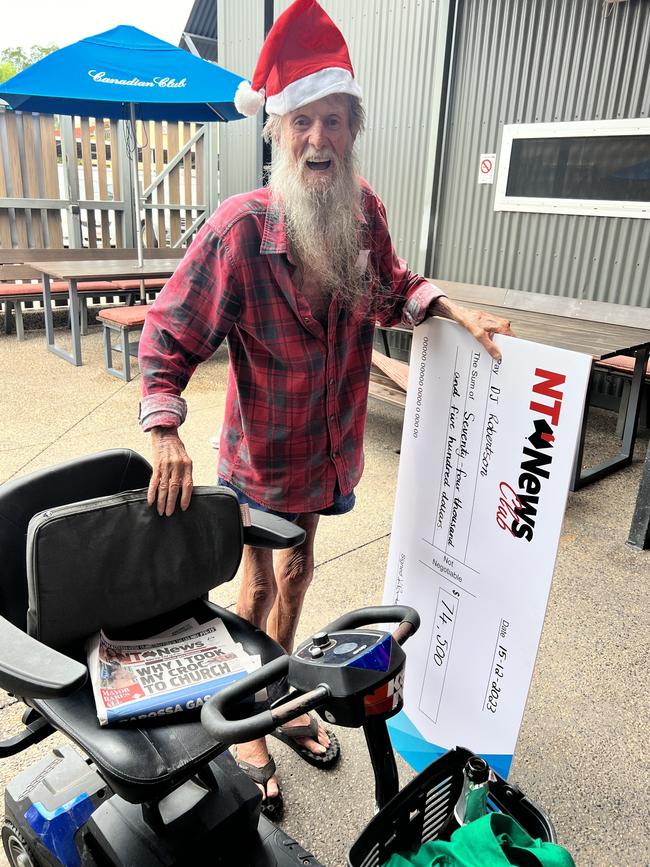 Sunday Territorian bingo winner DJ Robertson with his cheque for $74,500, and his daily newspaper.