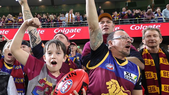 Lions fans celebrate after defeating the Blues in the preliminary final match at the Gabba. Picture: Lachie Millard