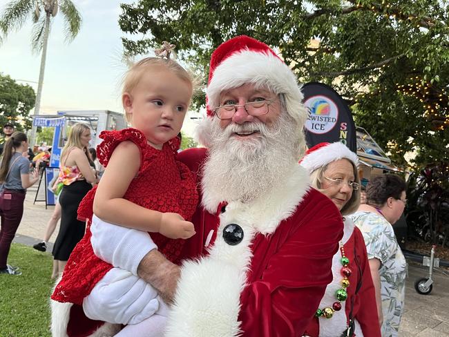 Cartei having cuddles with Santa at the street party.