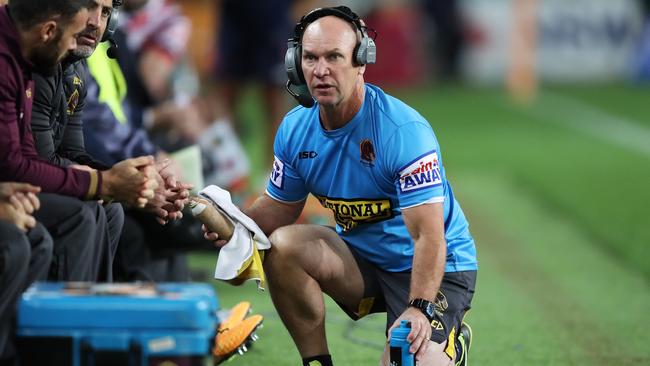 Langer getting orders from the coach’s box before heading onto the field. Picture: Brett Costello