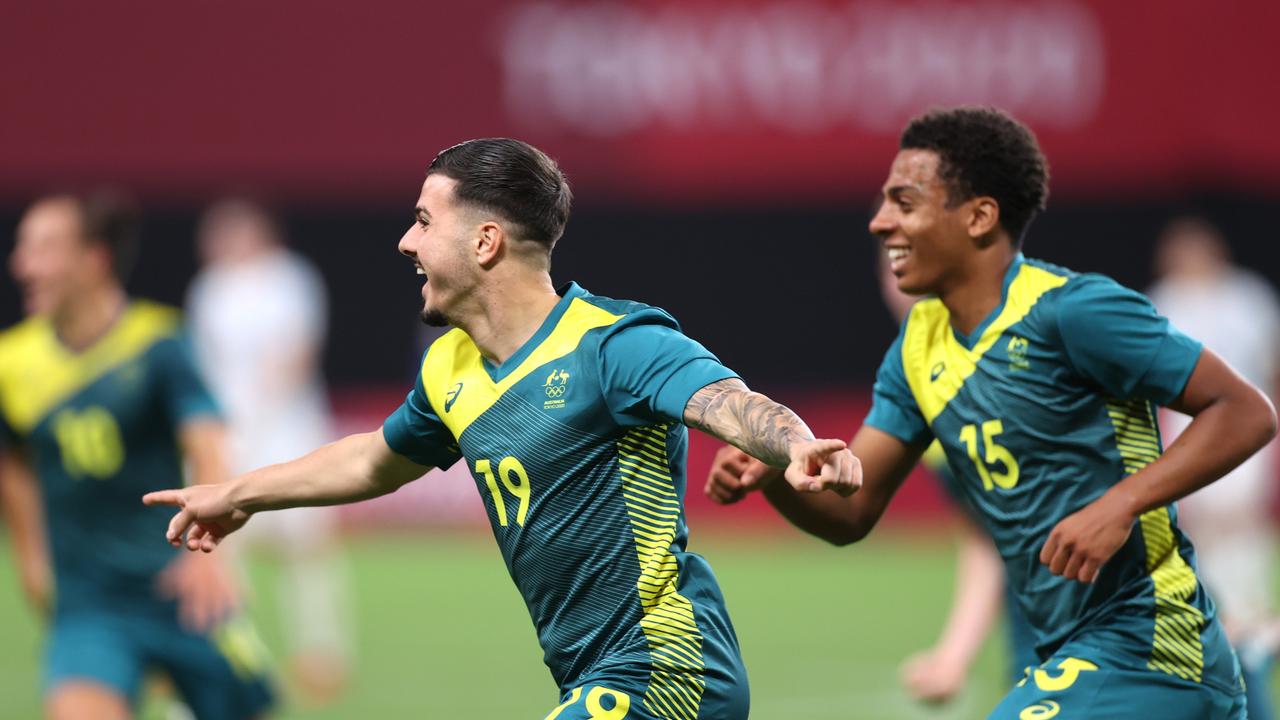 Marco Tilio wheels off in celebration after scoring the Olyroos’ second goal.