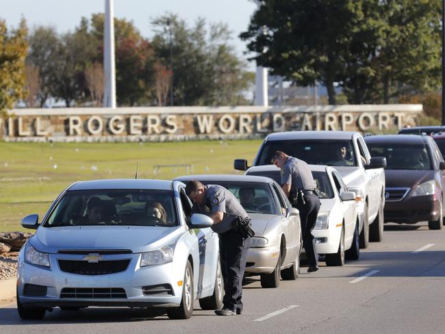 Oklahoma City police officers gather information from vehicles leaving Will Rogers World Airport. Picture: Steve Gooch/The Oklahoman.