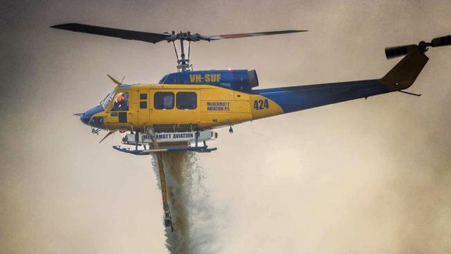 A McDermott Aviation helicopter in action on Wednesday at Palmview. Photo: Glen Vidler