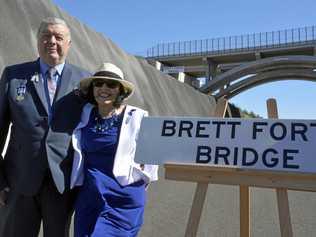 BRIDGES NAMED: Stuart and Heather Forte, the parents of police officer Brett Forte who died in the line of duty in 2017, with the Brett Forte Bridge in the background. Picture: Tobi Loftus