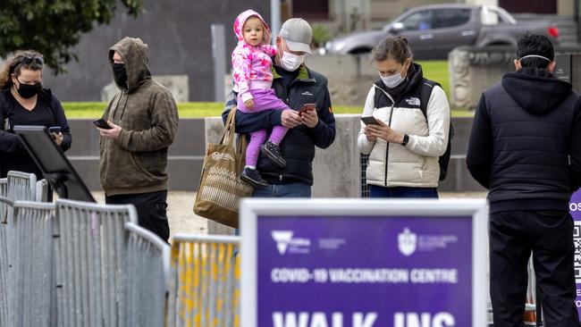 People line up at the vaccination hub at the Exhibition buildings in Carlton. Picture: NCA NewsWire / David Geraghty