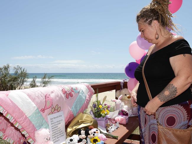 Jodie Devere of the Gold Coast pays tribute to the baby that was found dead on the beach in Surfers Paradise near Staghorn Ave. Photo: Tertius Pickard