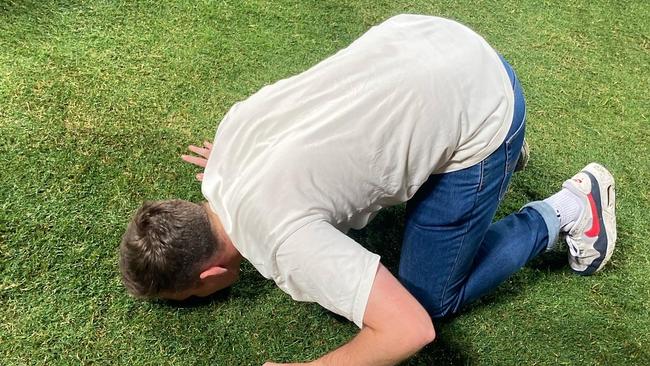 Will Hogan kisses the spot where Lance Franklin kicked his 1000th goal.