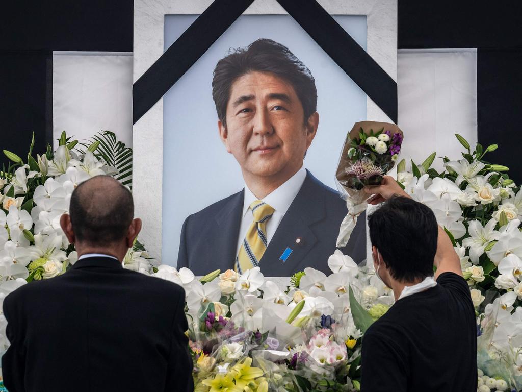 People leave flowers and pay their respects to former Japanese prime minister Shinzo Abe outside the Nippon Budokan in Tokyo on September 27, 2022. Picture: Yuichi Yamazaki/AFP