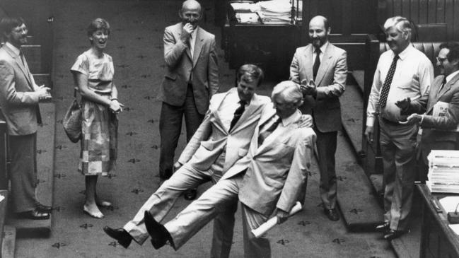 Liberal MLC Legh Davis and Australian Democrat leader Lance Milne do an impromptu jig in the Legislative Council as a marathon parliamentary session ends in 1984, watched by other MLCs Trevor Griffin, Diana Laidlaw, Martin Cameron, Chris Sumner, Gordon Bruce and Ian Gilfillan.