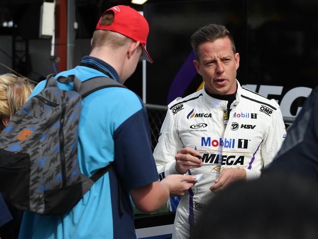 James Courtney signs an autograph for a fan at the Ipswich SuperSprint at Queensland Raceway on Friday.