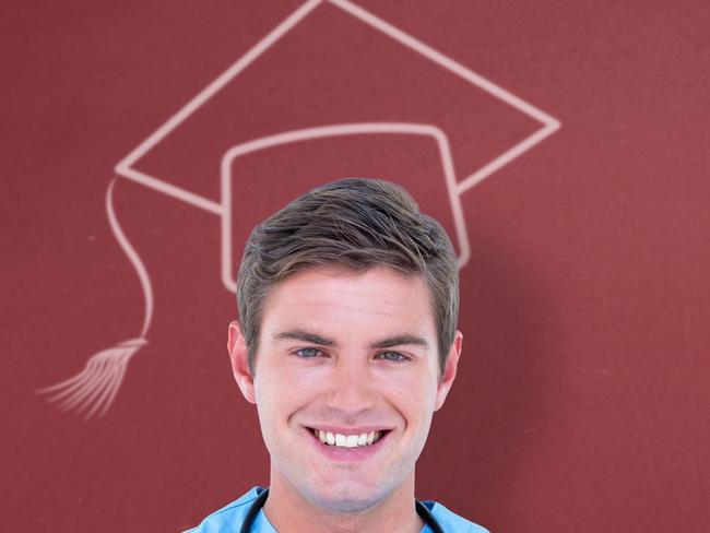 Young nurse in blue tunic with arms crossed against red background.Nurse graduate male. iStock