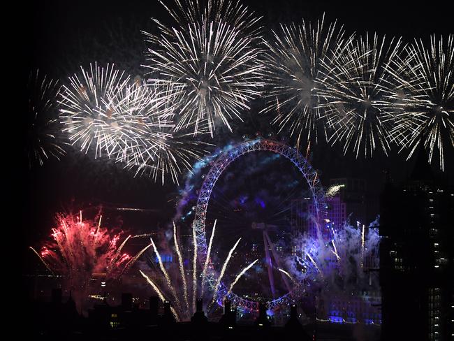 Fireworks explode over The Coca-Cola London Eye, Westminster Abbey and Elizabeth Tower near Parliament as thousands of revelers gather along the banks of the River Thames. Picture: Getty